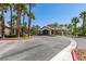 A view of the well-manicured clubhouse surrounded by tall palm trees and lush landscaping at 8250 N Grand Canyon Dr # 2001, Las Vegas, NV 89166