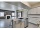 An open concept kitchen/living area with wood-look floors, stainless appliances, and granite countertops at 8250 N Grand Canyon Dr # 2001, Las Vegas, NV 89166