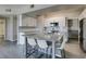 Beautiful kitchen features white cabinetry, stainless steel appliances, a center island and modern fixtures at 8250 N Grand Canyon Dr # 2001, Las Vegas, NV 89166