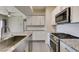 Well-equipped kitchen features stainless steel appliances, a center island, white cabinets and plenty of counter space at 8250 N Grand Canyon Dr # 2001, Las Vegas, NV 89166