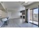 Spacious open floor plan with a modern kitchen, fireplace, light gray floors, and a private balcony at 8250 N Grand Canyon Dr # 2001, Las Vegas, NV 89166