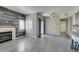 Open-concept living space with wood-look floors, a fireplace, and sliding glass doors that bring in plenty of natural light at 8250 N Grand Canyon Dr # 2001, Las Vegas, NV 89166