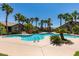 The community pool area features a rock waterfall, tropical plants, and lounge chairs at 8250 N Grand Canyon Dr # 2001, Las Vegas, NV 89166