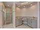 Bathroom with double sinks, granite countertops, and a glass-enclosed shower at 8300 Slate Harbor Cir, Las Vegas, NV 89128