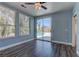 Bedroom with a ceiling fan, wood floors, and sliding door access to the backyard pool at 8300 Slate Harbor Cir, Las Vegas, NV 89128