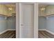 Walk-in closets with wood floors, custom shelving, and chandelier lighting at 8300 Slate Harbor Cir, Las Vegas, NV 89128