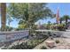 Welcoming community entrance with attractive signage, colorful flowers, and well-maintained landscaping at 8300 Slate Harbor Cir, Las Vegas, NV 89128