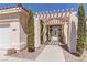 Inviting home entrance framed by mature trees and a covered walkway at 8300 Slate Harbor Cir, Las Vegas, NV 89128