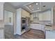 Modern kitchen features white cabinets, stainless steel appliances, and granite countertops at 8300 Slate Harbor Cir, Las Vegas, NV 89128