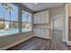 Eat-in kitchen area with pool views through large windows and modern wood-look floors at 8300 Slate Harbor Cir, Las Vegas, NV 89128