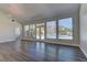 Light-filled living room featuring hardwood floors and a view of the backyard pool at 8300 Slate Harbor Cir, Las Vegas, NV 89128