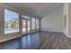 Hardwood floors and large windows highlight this beautiful living room overlooking the pool at 8300 Slate Harbor Cir, Las Vegas, NV 89128