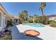 Outdoor pool with palm trees, lush landscaping, and a patio area at 8300 Slate Harbor Cir, Las Vegas, NV 89128