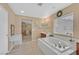Bright bathroom features a soaking tub, double vanity and a separate dressing table at 8335 Martinborough Ave, Las Vegas, NV 89131