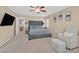 Large bedroom featuring a sitting area, carpeted floors, and a ceiling fan at 8335 Martinborough Ave, Las Vegas, NV 89131