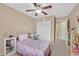 This bedroom includes a ceiling fan, closet, and a floral comforter on the bed at 8335 Martinborough Ave, Las Vegas, NV 89131
