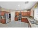 Spacious kitchen with stainless steel appliances, granite countertops and a breakfast bar seating three at 8335 Martinborough Ave, Las Vegas, NV 89131