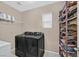 Laundry room with modern washer and dryer, storage shelf, and tiled flooring at 8335 Martinborough Ave, Las Vegas, NV 89131