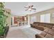 Open-concept living room and kitchen layout with a sectional sofa, ceiling fan and breakfast bar at 8335 Martinborough Ave, Las Vegas, NV 89131