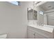 Bathroom featuring a modern vanity with a mirror, adjacent to a shower and toilet at 8396 Pearl Beach Ct, Las Vegas, NV 89139