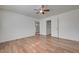 Spacious bedroom with wood-look floors and views of a bathroom and closet through doorways at 8396 Pearl Beach Ct, Las Vegas, NV 89139