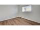 Empty bedroom featuring a window, wood floors and white walls at 8396 Pearl Beach Ct, Las Vegas, NV 89139