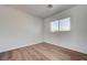 A bedroom featuring a window with blinds and wood-look flooring at 8396 Pearl Beach Ct, Las Vegas, NV 89139
