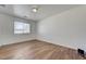 Bright bedroom with wood-look floors and a large window offering natural light at 8396 Pearl Beach Ct, Las Vegas, NV 89139