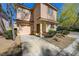 Inviting two-story home with an attached garage, desert landscaping, and covered front porch at 8396 Pearl Beach Ct, Las Vegas, NV 89139