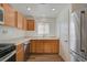 Well-lit kitchen featuring wood cabinets, modern appliances, and a window over the sink at 8396 Pearl Beach Ct, Las Vegas, NV 89139