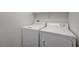 Laundry room featuring full-sized, white, washer and dryer units with shelving at 8396 Pearl Beach Ct, Las Vegas, NV 89139