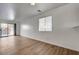 Bright living room featuring wood floors, sliding glass doors, and a window at 8396 Pearl Beach Ct, Las Vegas, NV 89139