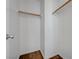 A walk-in closet featuring wooden storage bars and wood-look floors at 8396 Pearl Beach Ct, Las Vegas, NV 89139