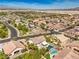 Wide aerial shot showcases neighborhood, pools, and desert landscape at 8516 Canyon Ranch St, Las Vegas, NV 89131