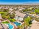 Overhead view of a home with a pool, spa, and well-manicured lawn at 8516 Canyon Ranch St, Las Vegas, NV 89131