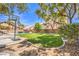 The backyard boasts a grassy lawn, mature trees, a pool and a basketball court at 8516 Canyon Ranch St, Las Vegas, NV 89131