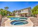 Expansive backyard pool, spa, covered patio, grassy area and views of the home at 8516 Canyon Ranch St, Las Vegas, NV 89131