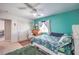 Bedroom with a wooden desk, tropical themed bedding, and turquoise walls at 8516 Canyon Ranch St, Las Vegas, NV 89131