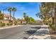 Gated community entrance with well-maintained landscaping and palm trees at 8516 Canyon Ranch St, Las Vegas, NV 89131