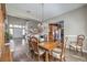 Open-concept dining room featuring hardwood floors, chandelier, and adjoining living room at 8516 Canyon Ranch St, Las Vegas, NV 89131