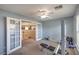 Exercise room with a weight lifting bench and view to second story landing through glass paneled doors at 8516 Canyon Ranch St, Las Vegas, NV 89131