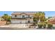 Two-story home with a three car garage and manicured landscaping at 8516 Canyon Ranch St, Las Vegas, NV 89131