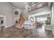 Open concept living room featuring a staircase, white piano, and dining area at 8516 Canyon Ranch St, Las Vegas, NV 89131