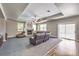 Open-concept living room with fireplace, ceiling fan, hardwood floors, and sliding glass doors at 8516 Canyon Ranch St, Las Vegas, NV 89131