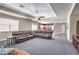 Open living room with a leather couch and fan leads to a kitchen at 8516 Canyon Ranch St, Las Vegas, NV 89131