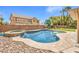 Sparkling backyard pool and spa is surrounded by rock landscaping and a grassy lawn at 8516 Canyon Ranch St, Las Vegas, NV 89131
