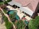 Aerial view of the backyard pool, patio, home and colorful landscaping featuring desert plants and flowers at 8608 Willow Cabin St, Las Vegas, NV 89131