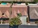 An aerial view showcasing the home's tile roof, driveway, landscaping, proximity to neighbors, and neighborhood at 8608 Willow Cabin St, Las Vegas, NV 89131