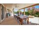 Inviting backyard with a large outdoor dining table and swimming pool at 8608 Willow Cabin St, Las Vegas, NV 89131