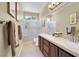 Well lit bathroom featuring a double vanity and glass shower at 8608 Willow Cabin St, Las Vegas, NV 89131